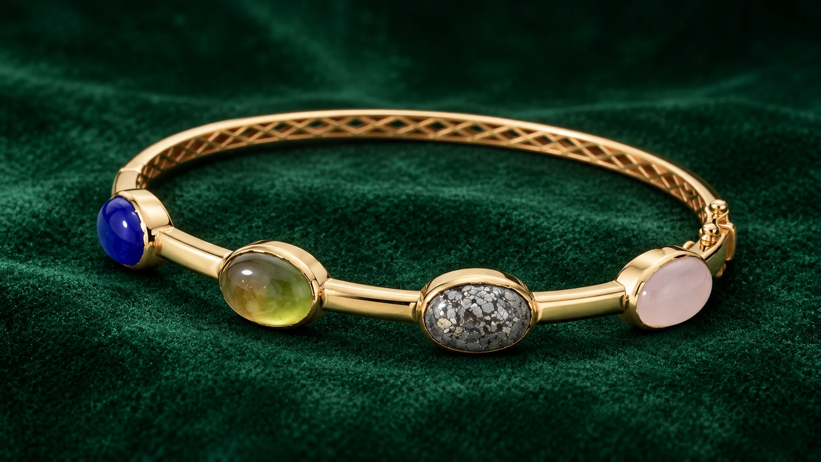 Bespoke four-stone 18K yellow gold bangle on emerald velvet