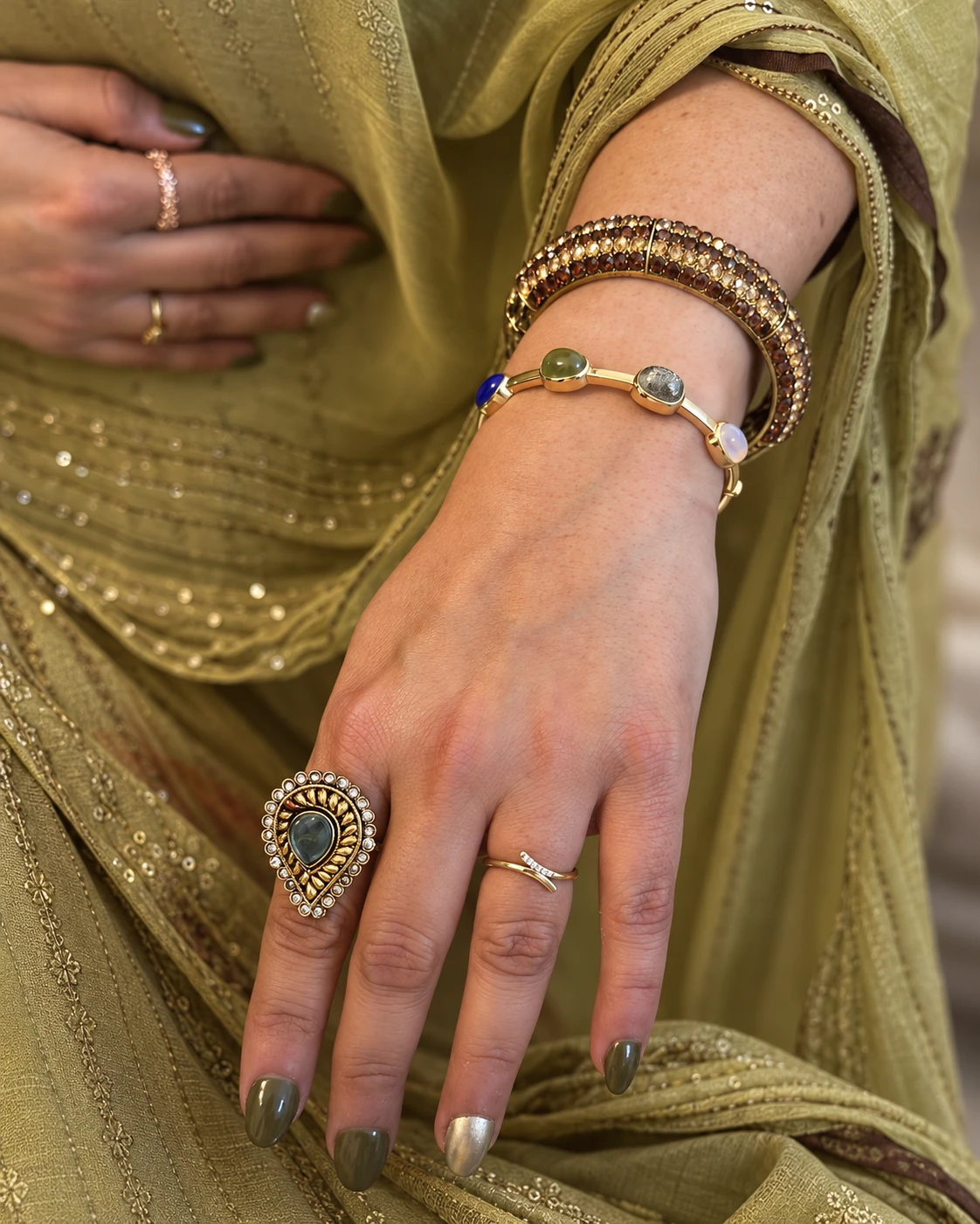 The private client wearing her four-stone yellow gold bangle with olive traditional attire